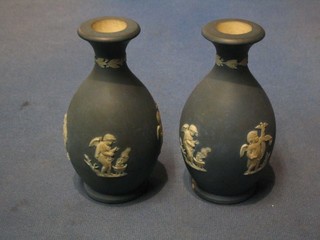 A pair of "19th Century" Wedgwood blue jasperware vases of club form decorated cherubs 5 1/2" (one with chip to base), impressed Wedgwood 411