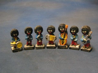 A 7 piece terracotta Robinson's Gollywog band with some damage, chips to the bases