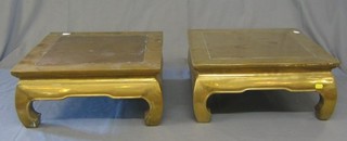A pair of Oriental bronze opium tables raised on cabriole supports