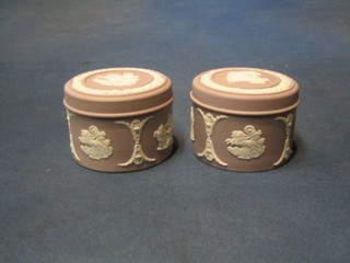 A pair of circular Wedgwood pink Jasperware jars and covers, bases marked Wedgwood 60, 2"