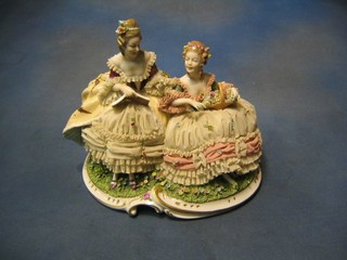 A Continental porcelain figure group of 2 seated Crinoline ladies, the base marked Unter Weissbach 12"