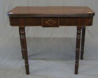 A 19th Century mahogany D shaped card table, raised on ring turned supports 36"