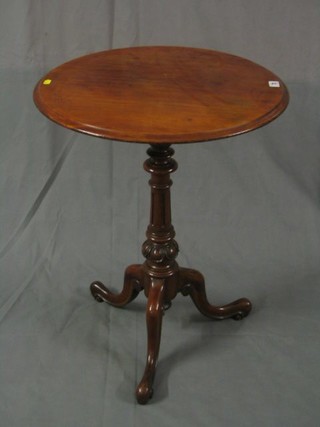 A Victorian circular mahogany wine table raised on bulbous turned and tripod supports 22"