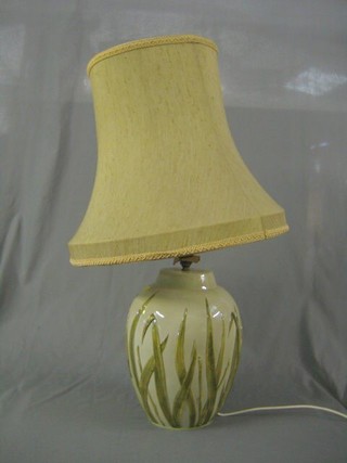A globular shaped pottery  table lamp decorated reeds 15"