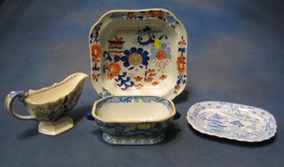 A 19th Century masons style sauce boat 8", a Masons painted Ironstone China dish 10", a blue and white lozenge shaped meat plate 7" decorated the Willow pattern and a blue and white painted ironstone sauce tureen 7"
