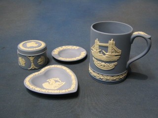 A 1975 Wedgwood blue Jasperware tankard decorated Tower Bridge, a heart shaped ashtray, a circular ashtray and a small jar and cover