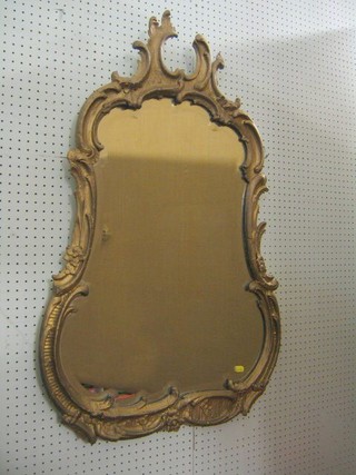 A 19th Century French bevelled plate wall mirror contained in Rococo style a gilt frame 39"