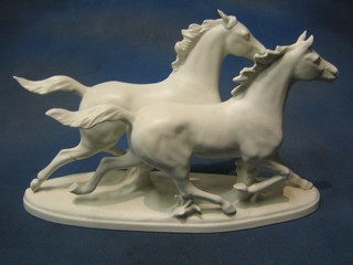 A Goebal figure of 2 running white horses, the base marked Goebal and incised 2055, raised on an oval base 17" (tail f and r)