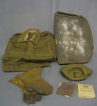 A WWII Royal Artillery Private's Battle dress blouse and trousers together with service scarf, 2 pairs of braces, handkerchiefs, shorts, trousers, shirt, kit bag, gauntlets and jack knife and beret formerly the property of and with black and white photograph of Gunner T N Burchell