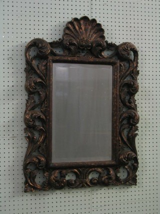 A rectangular Rococo style bevelled plate wall mirror contained in a pierced gilt  frame surmounted by a scallop shell 31" 