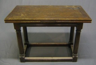 A 17th Century style oak refectory drawleaf dining table, raised on turned and block supports with box framed stretcher 43"