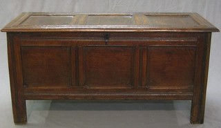 A 17th/18th Century oak coffer of panelled construction with hinged lid 53"