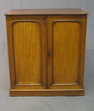 A Victorian walnutwood cabinet, the interior fitted shelves enclosed by arched panelled doors 30"