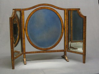 A 1930's triple plate dressing mirror contained in an ebonised frame