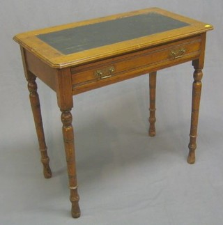 An Edwardian honey oak side table with inset writing surface, fitted a drawer, raised on turned supports 30"