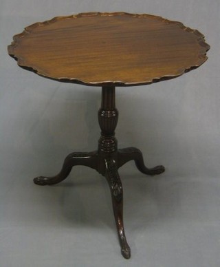 A 19th Century circular snap top wine table with pie crust edge, raised on a turned and reeded column with tripod supports ending in egg and claw feet 28"
