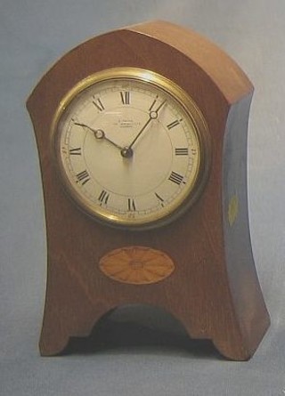 An Edwardian 8 day bedroom timepiece with enamelled dial and Roman numerals contained in an inlaid mahogany arch shaped case by E White, 32 The Haymarket