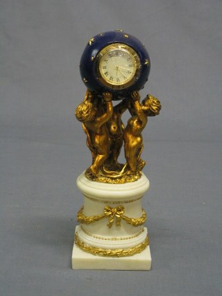 An Empire style mantel clock in the form of a star studded globe supported by 2 cherubs