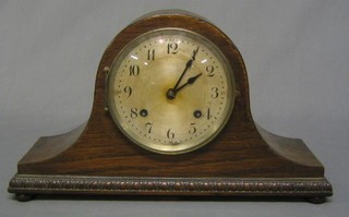 A  1930's striking mantel clock with silvered dial contained in an oak Admiral's hat case