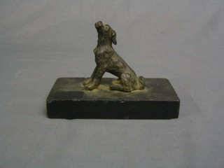 A bronze figure of a seated dog raised on a marble base