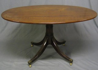 A 19th Century mahogany oval snap top breakfast table, raised on gun barrel turned column with tripod supports ending in brass caps and castors 52"