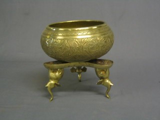A circular Eastern engraved brass bowl supported by elephants 8"