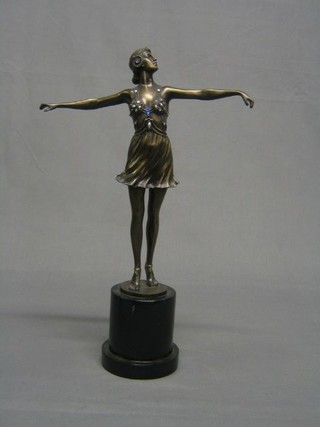 A bronzed Art Deco style figure of a lady dancer, on an ebonised socle base