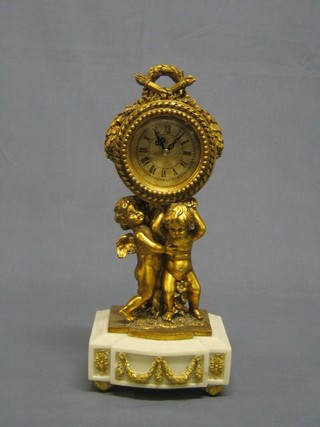 A reproduction Louis XVI table clock with Arabic numerals contained in a gilt case supported by cherubs