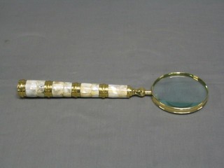 A large gilt metal magnifying glass with brass and faceted hard stone handle