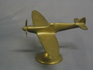 A brass model of a spitfire in flight 6"