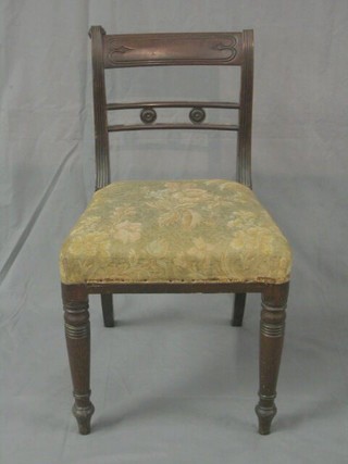A set of 4 Regency mahogany bar back dining chairs with pierced mid rail and upholstered seat on ring turned supports