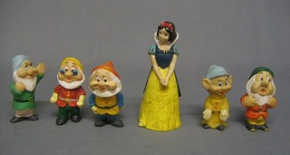A Chinese rubber figure of Snow White with 5 dwarfs contained in a wicker basket