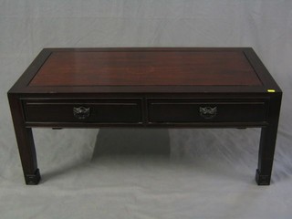 A rectangular Oriental Padouk wood table fitted 2 drawers with cats mask handles, raised on square supports 40"
