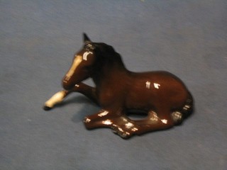 A Royal Doulton figure of a seated Chestnut foal, the base marked Royal Doulton 29 6"