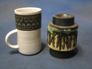 A circular Troica mug 4 1/2" mug and a Troica style jar and cover 4" (2)