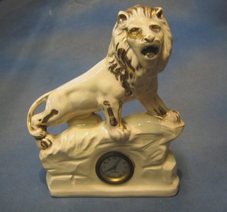 A 1930's German Devon timepiece contained in a pottery case surmounted by a figure of a lion 12"