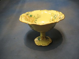 A pottery pedestal bowl with floral decoration