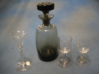A smoked glass decanter and stopper and a collection of glassware