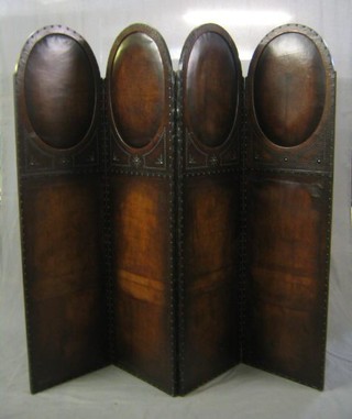 A 1920's Jacobean style arch shaped leather studded 4 fold dressing screen