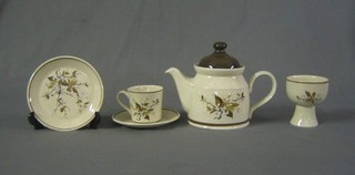 A 40 piece Royal Doulton Wind Cherry pattern dinner service comprising oval tureen and cover, 6 dinner plates, 7 side plates, 4 goblets, teapot, 4 egg cups, sauce boat, 6 cups and 6 saucers, 4 mugs