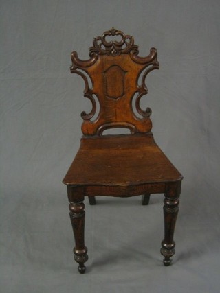 A Victorian oak hall chair with solid seat and back