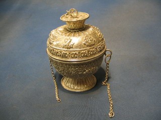 An impressive Eastern embossed silver urn and cover raised on a circular spreading foot, hung chains 7" 22 ozs