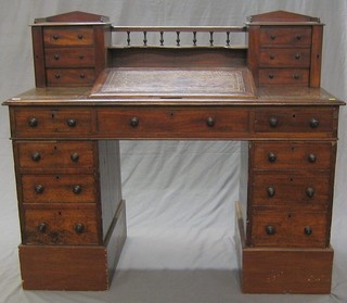 A Victorian mahogany Dickens style desk with raised super-structure to the back and gallery, flanked by a pair of pedestals fitted 6 drawers, having a slope to the middle inset a tooled leather writing surface above 9 drawers 54" 