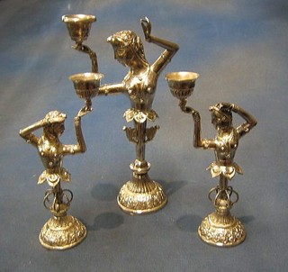 A set of 3 Eastern embossed silver candlesticks in the form of ladies torsos, raised on circular stems with circular spreading feet, 25 ozs