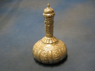An Eastern embossed silver bottle shaped urn and cover 8", 12 ozs