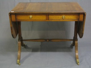 A Georgian style mahogany sofa table fitted 2 drawers, raised on fluted standard end supports united by a turned stretcher, 35"