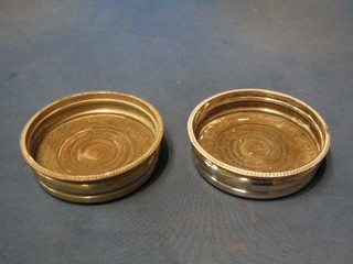 A pair of circular silver plated wine bottle coasters with gadrooned borders 5 1/2"
