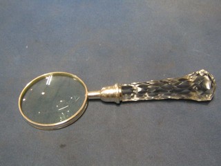 A magnifying glass with faceted glass handle