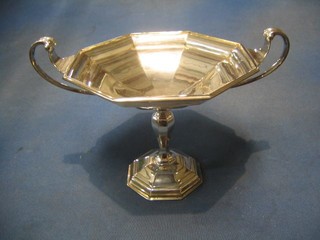 A silver poly-octagonal twin handled dish/trophy, raised on bulbous column with outswept foot, Birmingham 1929, 18 ozs