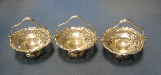 A set of 3 circular pierced silver bon bon dishes, raised on circular spreading feet, Birmingham 1925 and 1945, 7 ozs